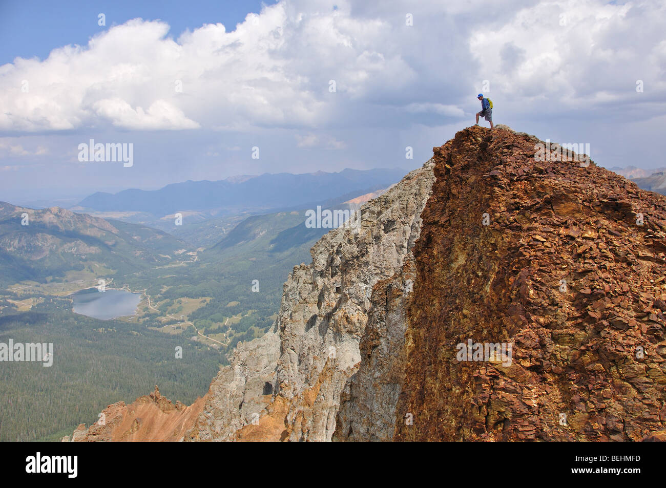 A hiker stands on top of East Sheep mountain in the San Juan mountains of Colorado Stock Photo