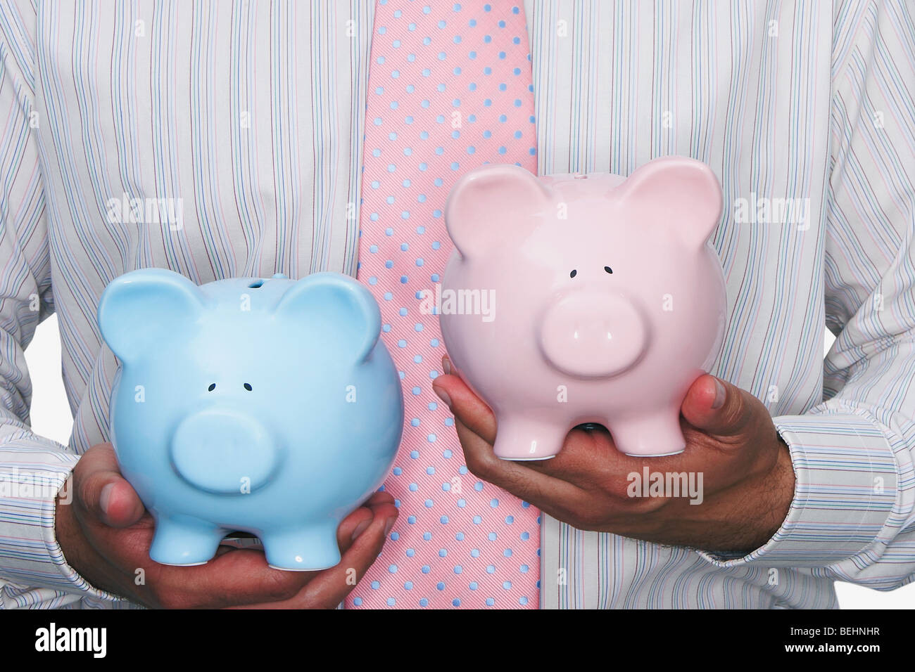 Mid section view of a businessman holding piggy banks Stock Photo - Alamy