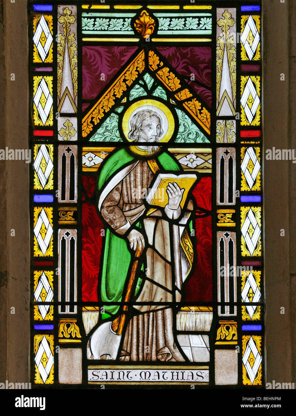 A stained glass window depicting St Mathias or Matthias the Apostle, All Saints Church, Wighton, Norfolk by Joseph Grant of Costessey Stock Photo