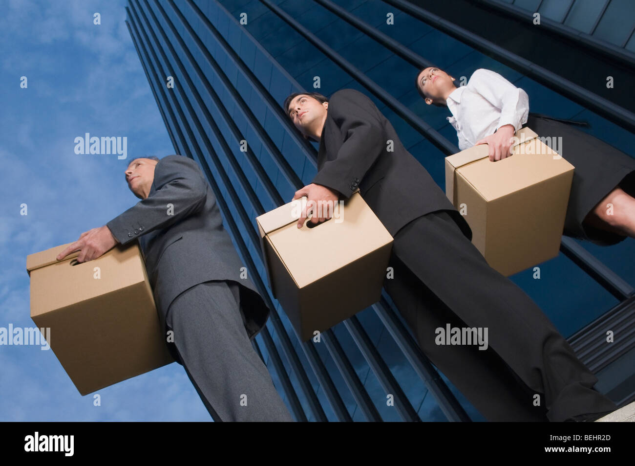 Low angle view of business executives carrying boxes Stock Photo