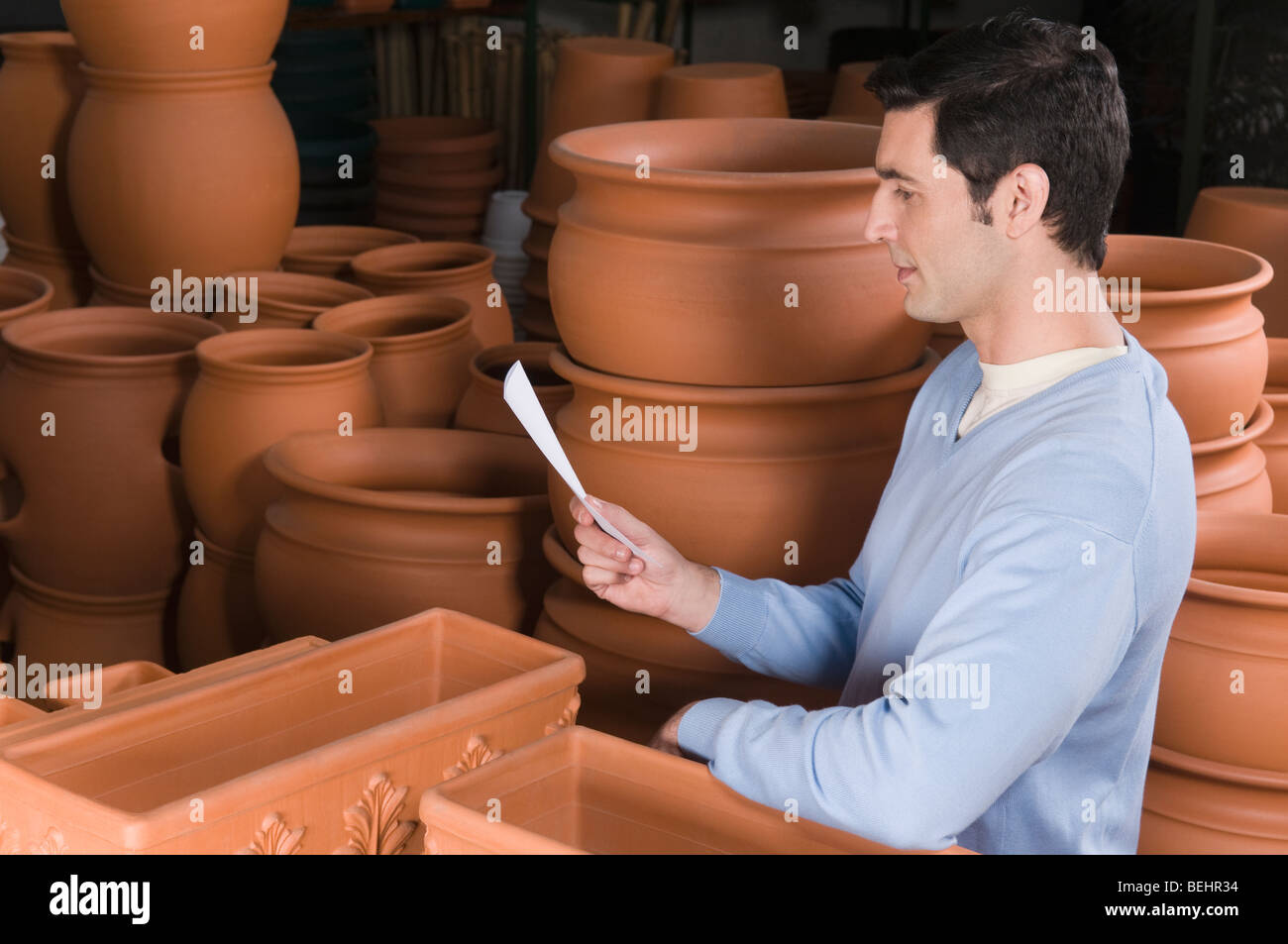 Man reading a shopping list in a garden center Stock Photo