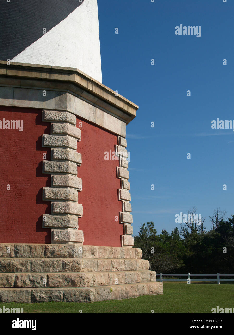 Base of lighthouse with green grass Stock Photo