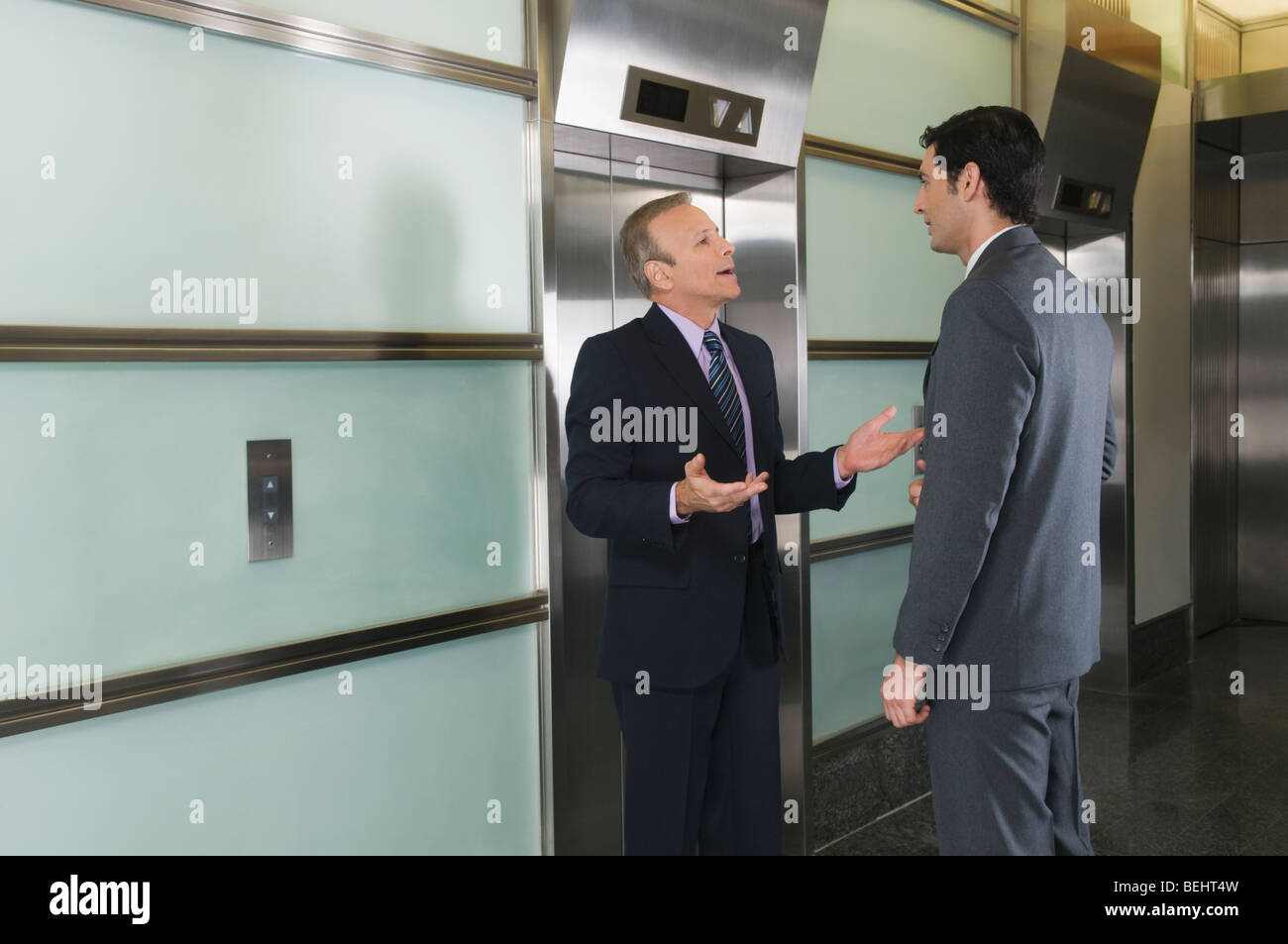 Businessmen discussing in a corridor Stock Photo