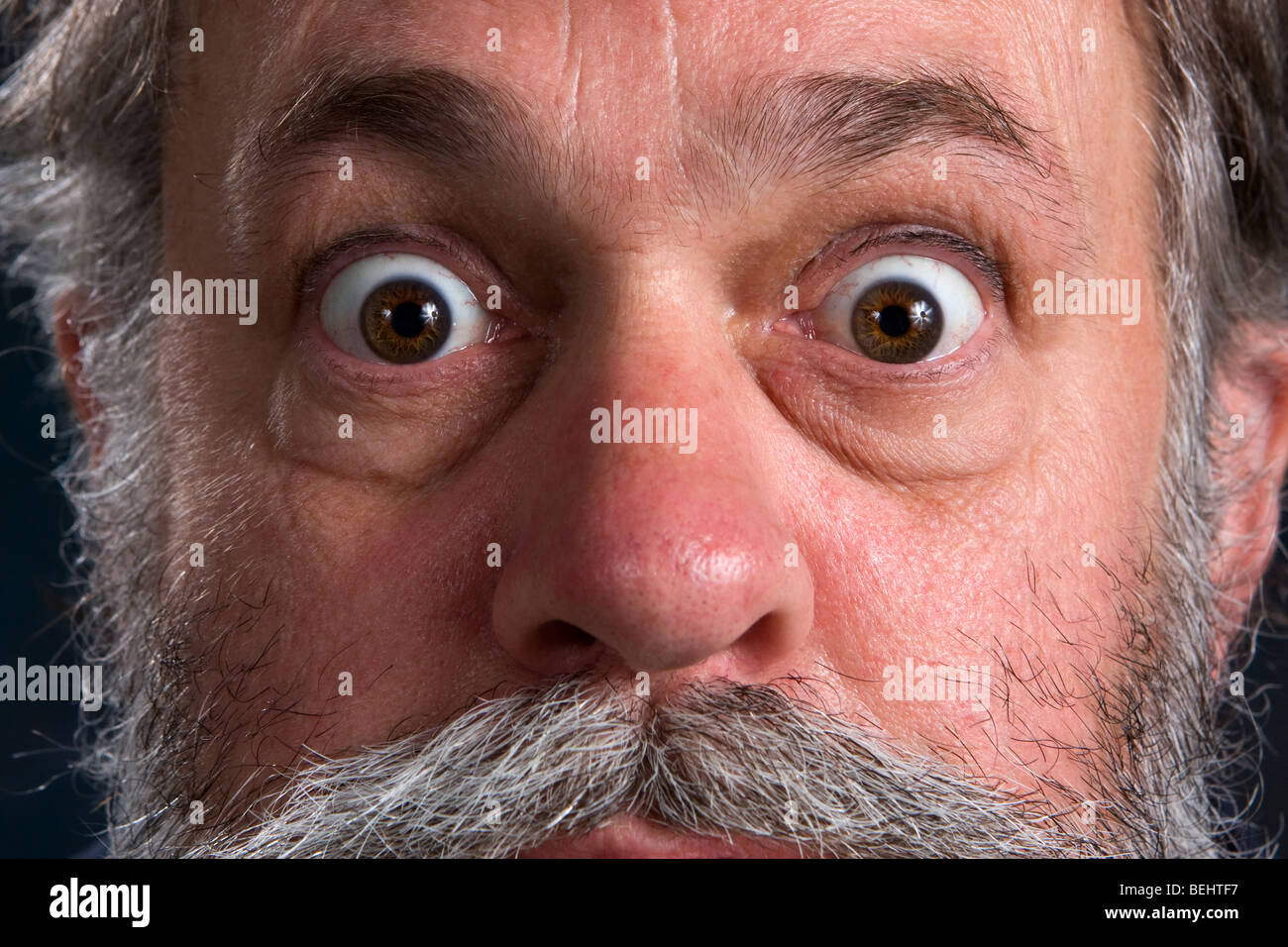 Wild eyed man with his eyes popped open. Stock Photo