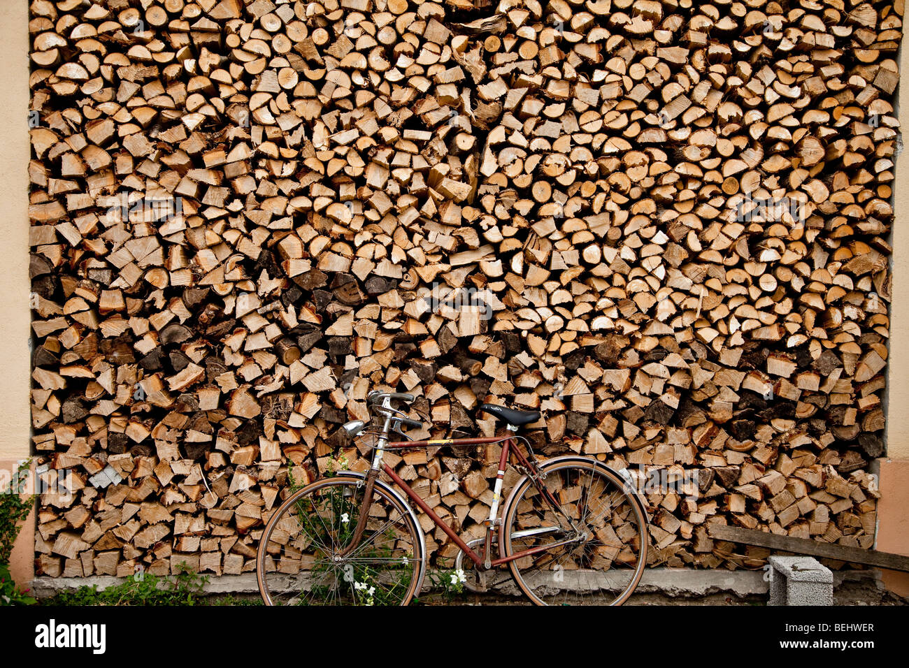 Firewood stack and bicycle at italian farm, Vicenza, Veneto, Italy Stock Photo