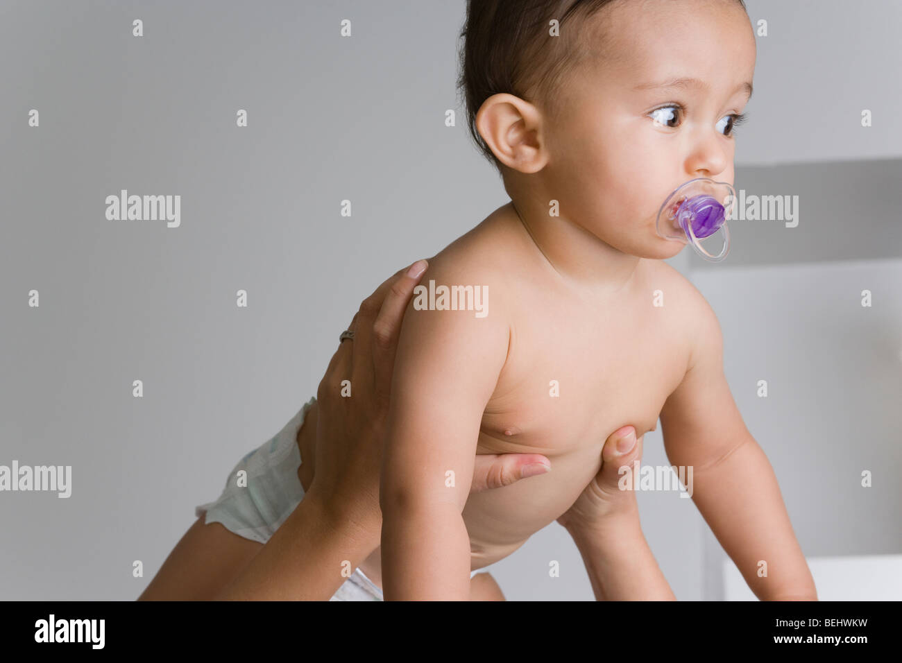 Baby boy sucking a pacifier Stock Photo