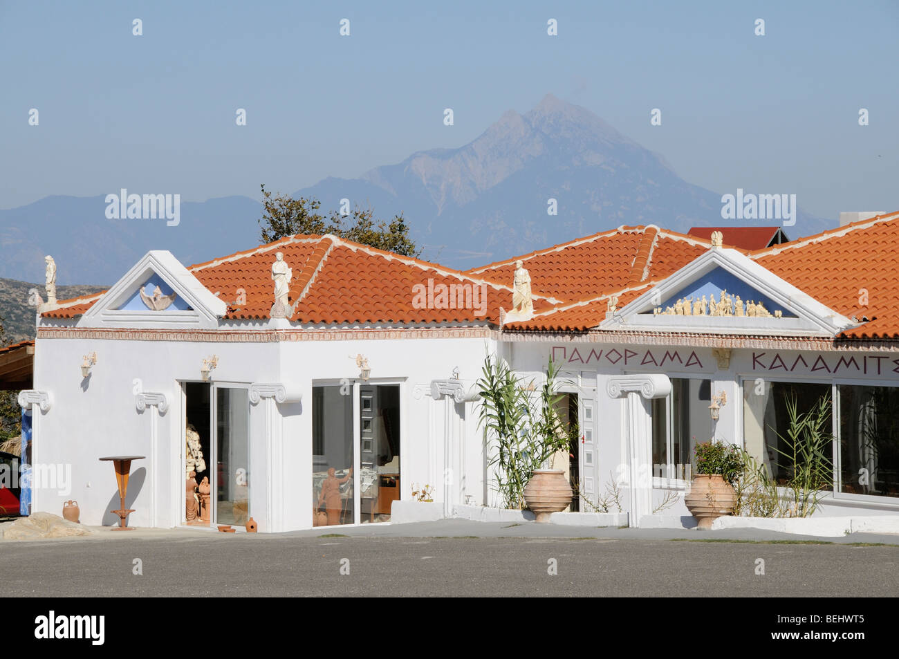 Modern Greek tavern on the roadside at Kalamitsi Sithonia Chalkidiki with a backdrop of Mount Athos northern Greece Stock Photo