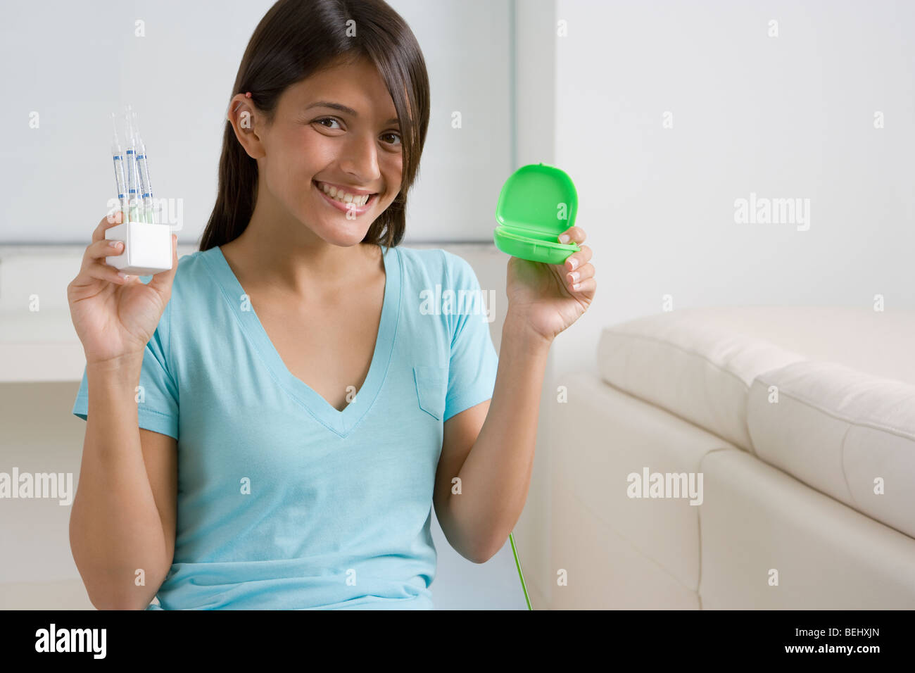 Teenage girl showing teeth whitening solution Stock Photo