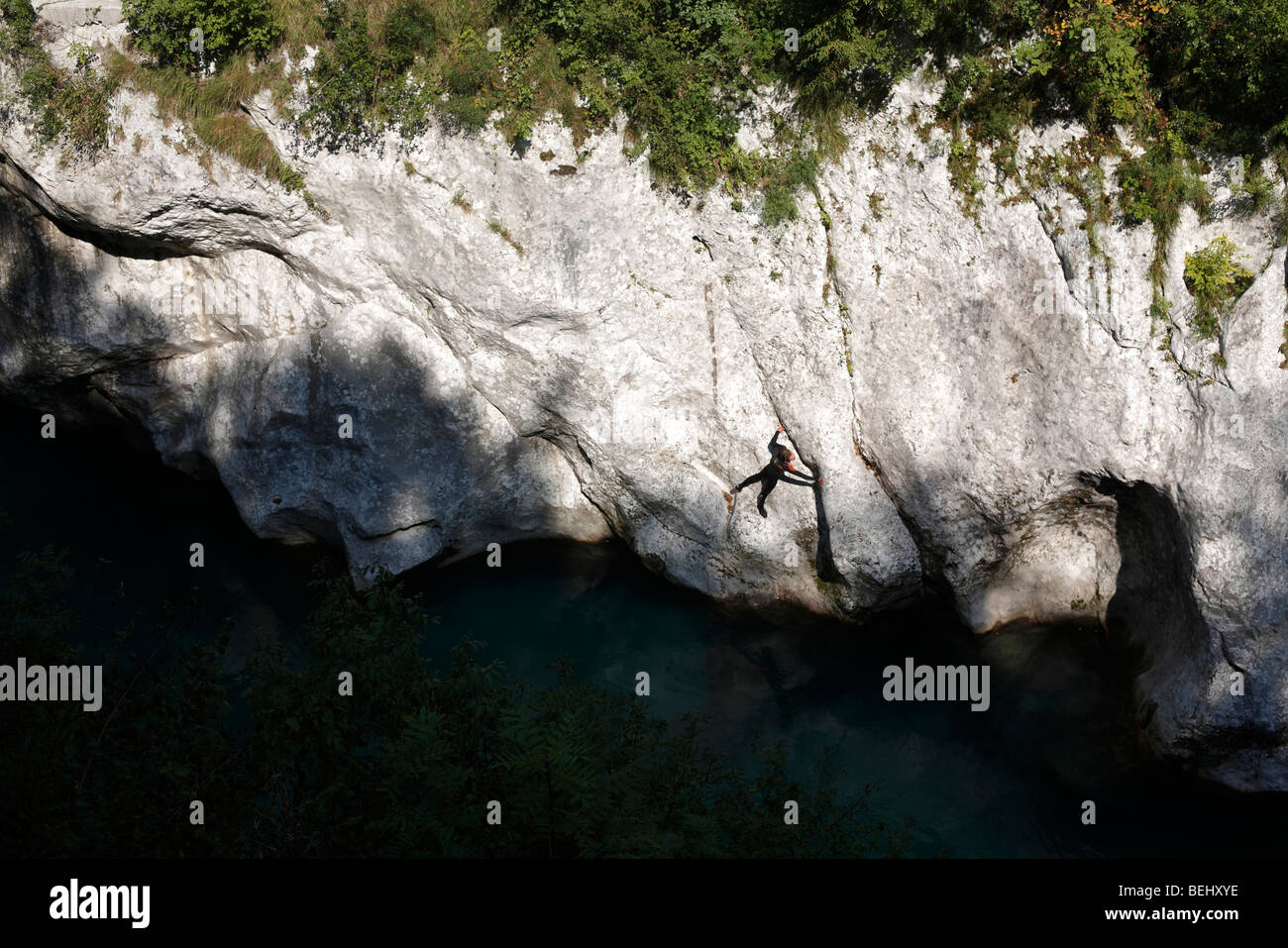 A man climbs the rock wall of the Soca river canyon near Kobarid in Slovenia Stock Photo