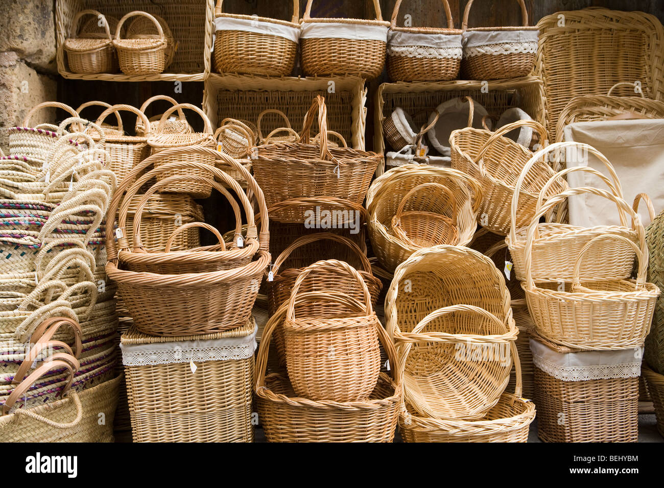 Stacked variety of traditional wickerwork baskets outside shop, Segovia, Spain Stock Photo