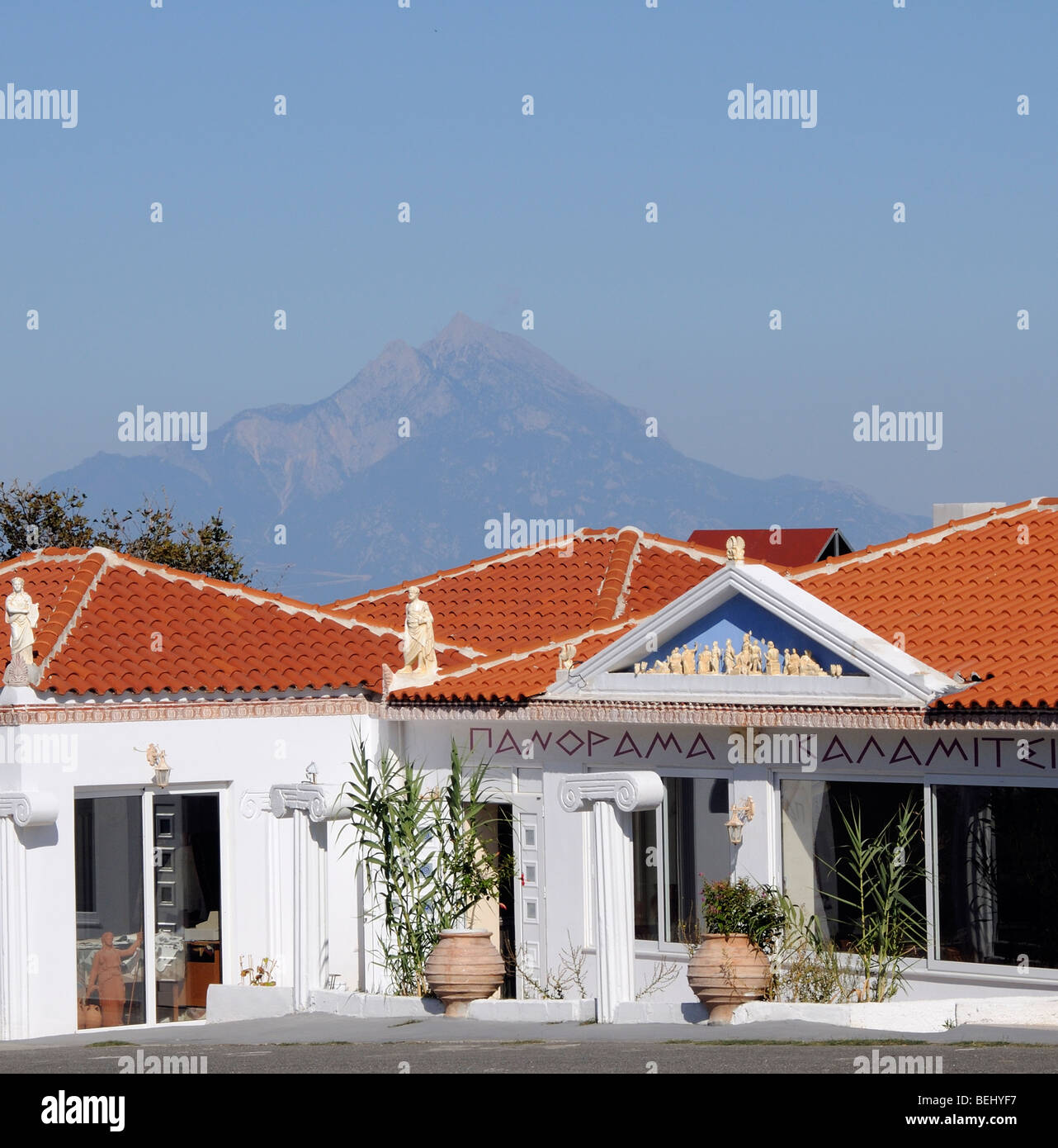 Modern Greek tavern on the roadside at Kalamitsi Sithonia Chalkidiki with a backdrop of Mount Athos northern Greece Stock Photo
