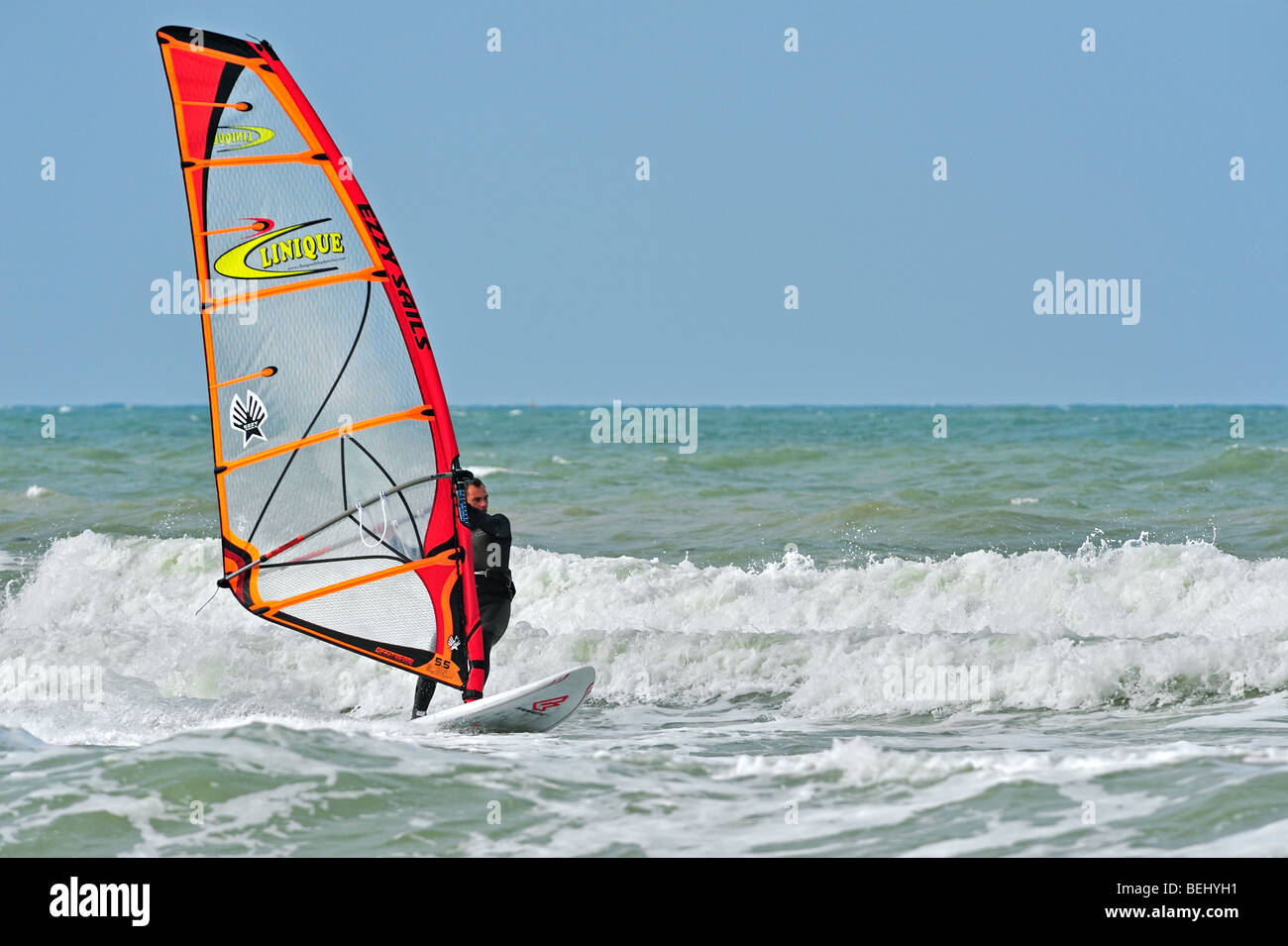 Windsurfer in wetsuit windsurfing on the North Sea on a stormy day Stock Photo