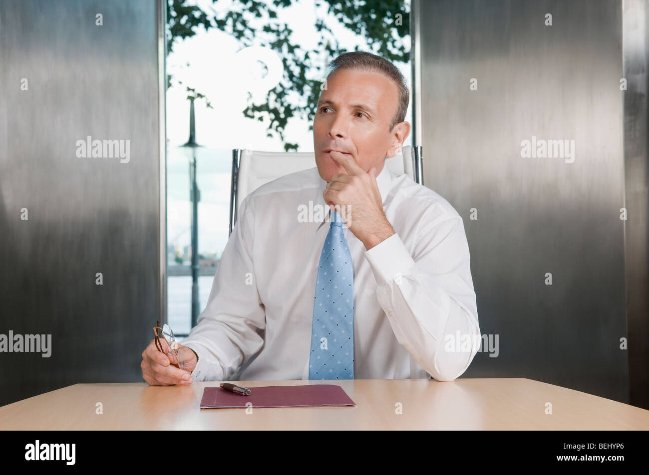 Businessman thinking in a board room Stock Photo