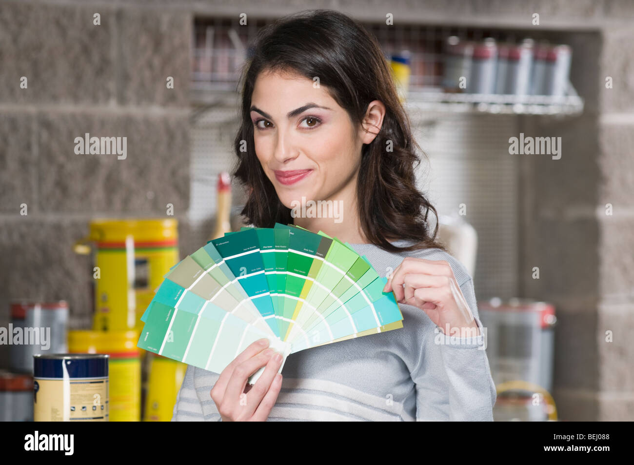 Woman holding color swatches in a hardware store Stock Photo
