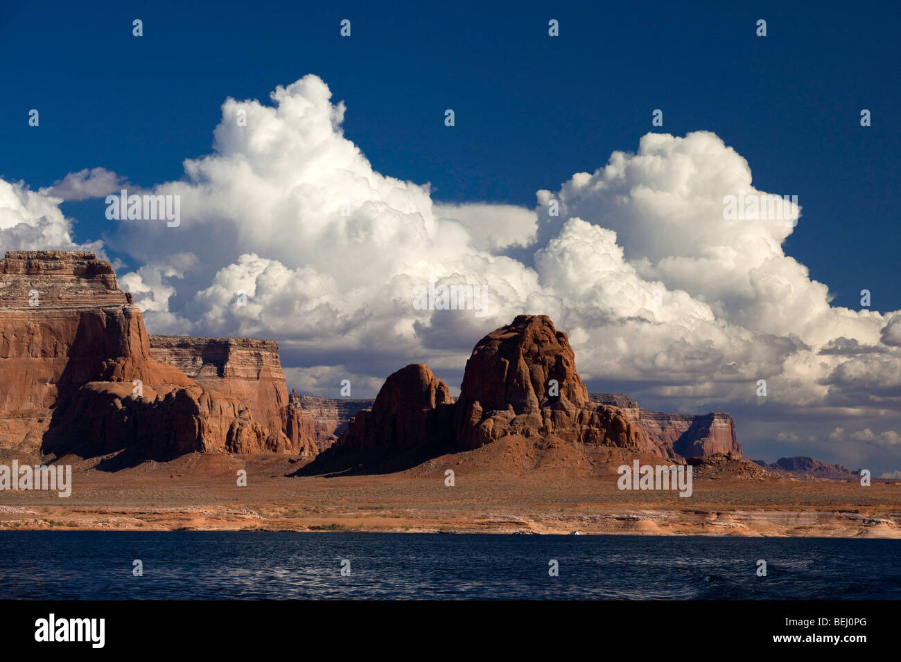 Red rock buttes and clouds on the shores of Lake Powell, Utah Stock Photo