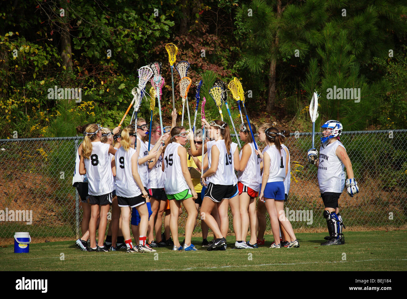 HIGH SCHOOL GIRLS LACROSSE TEAM BREAKS HUDDLE WITH STICKS IN THE AIR Stock Photo Alamy