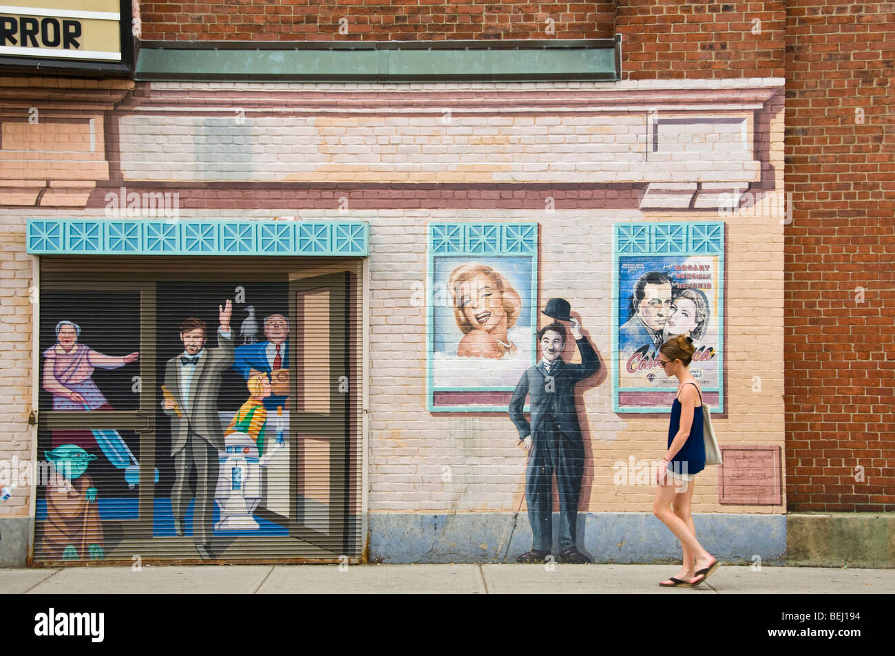 Woman walking in front off wall painting Cambridge, Massachusetts Stock Photo