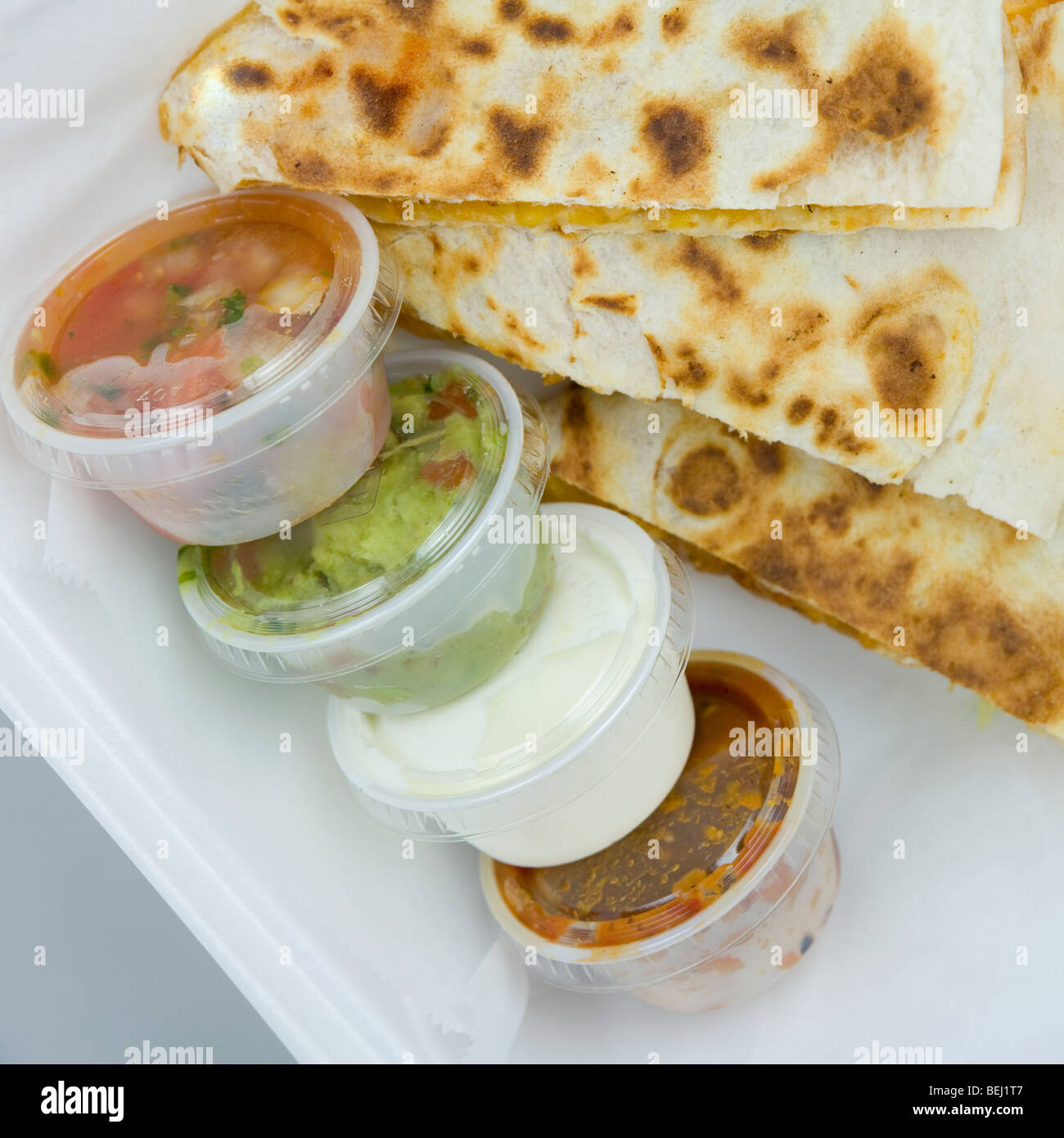 High angle view of quesadillas with assorted condiments Stock Photo