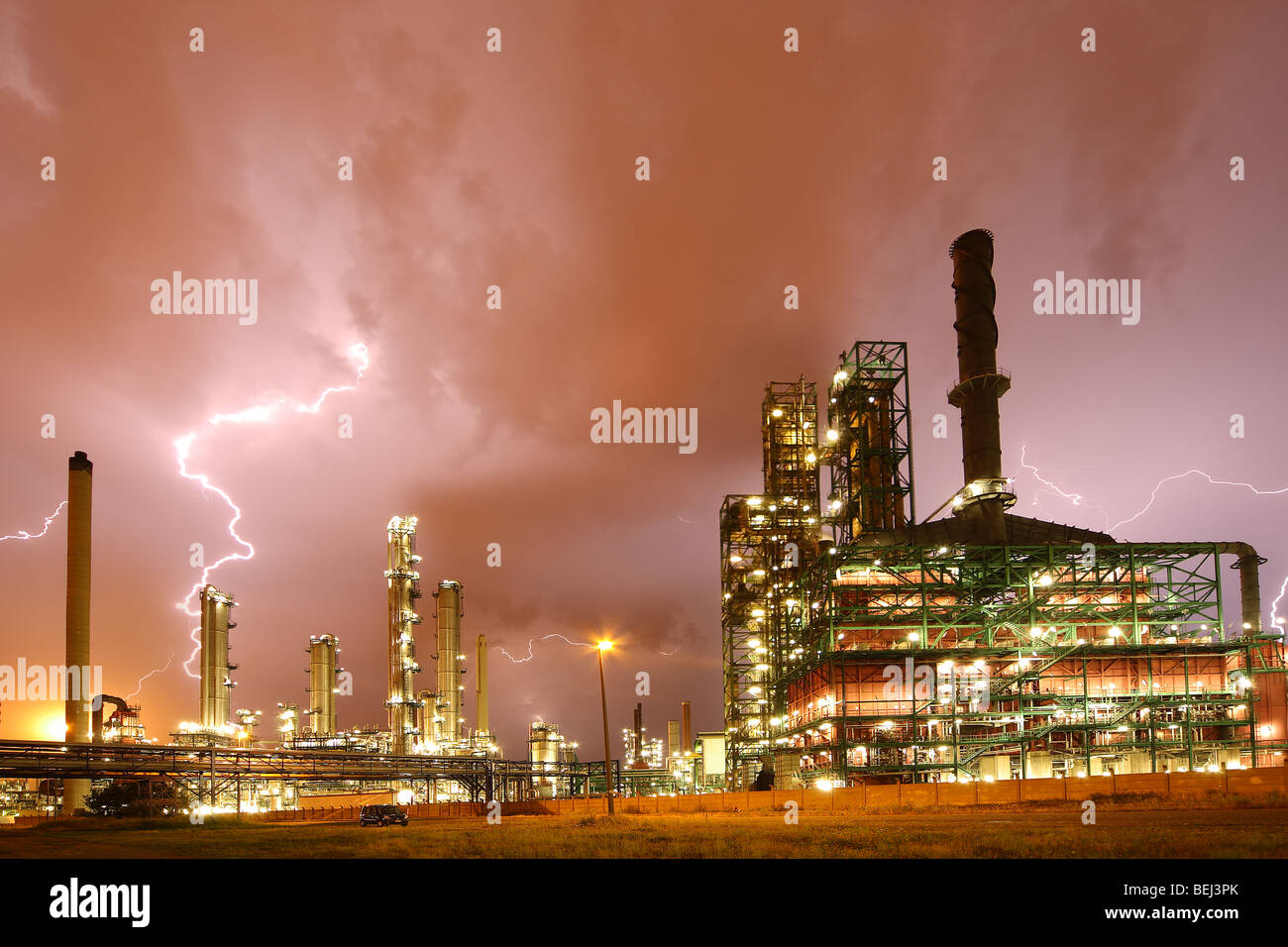 Lightning during thunderstorm above petrochemical industry in the Antwerp harbour at night, Belgium Stock Photo
