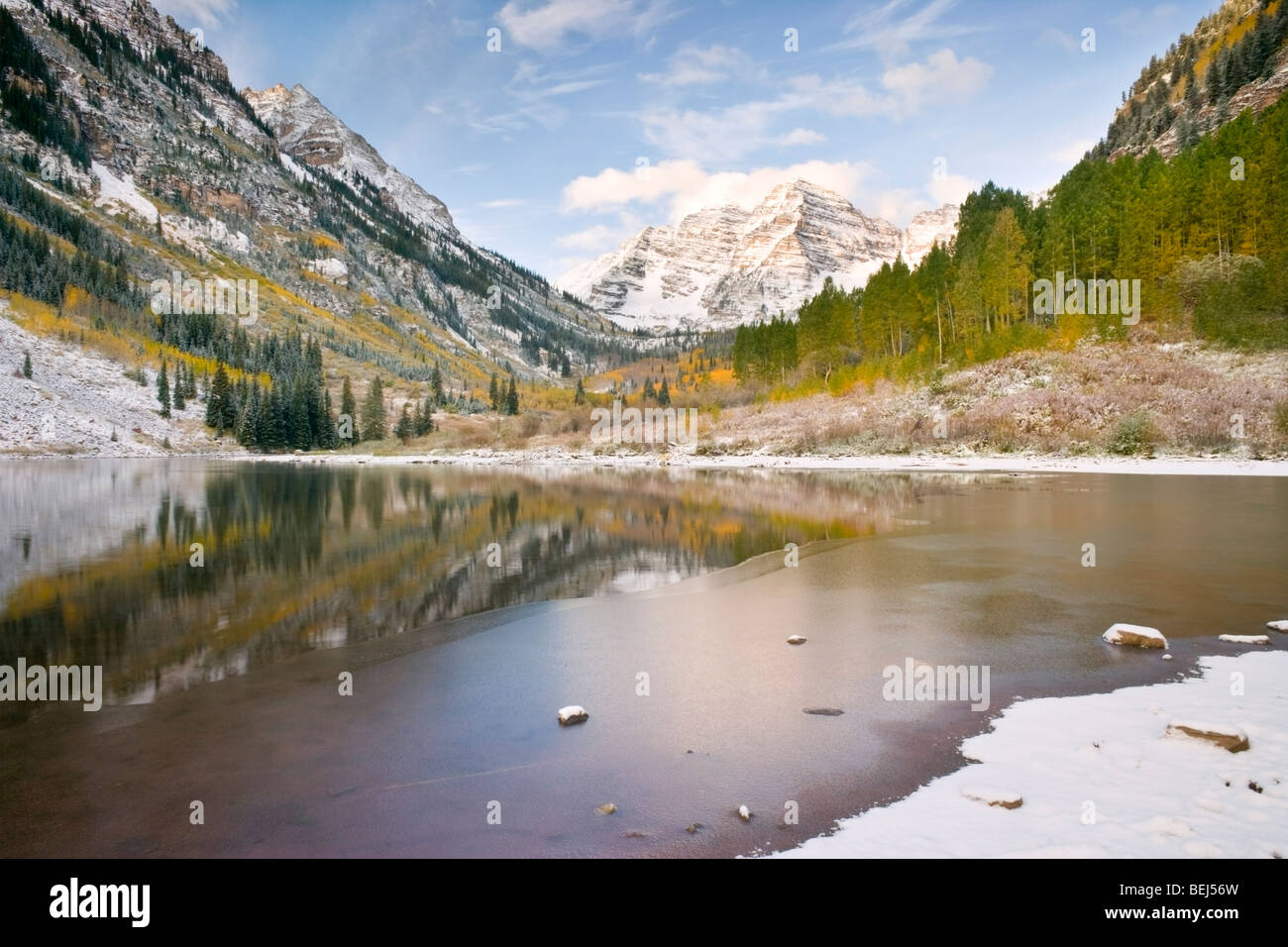 Maroon Bells during the fall season or winter season with frozen lake, ice and snow Stock Photo