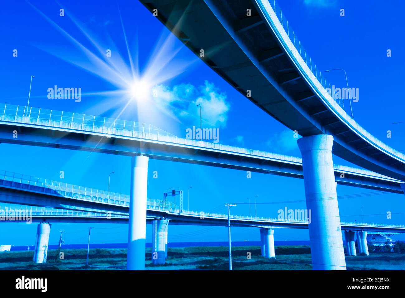 Expressway and solar flare,  Osaka,  Japan Stock Photo