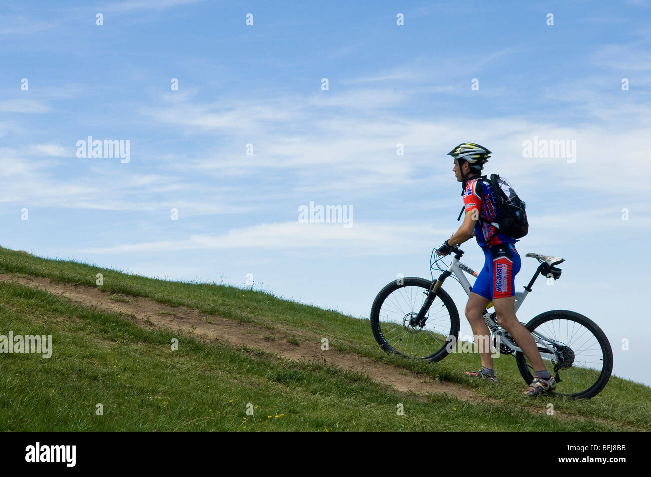 Cyclist towards the top, Guglielmo mountain, Lombardy, Italy Stock Photo