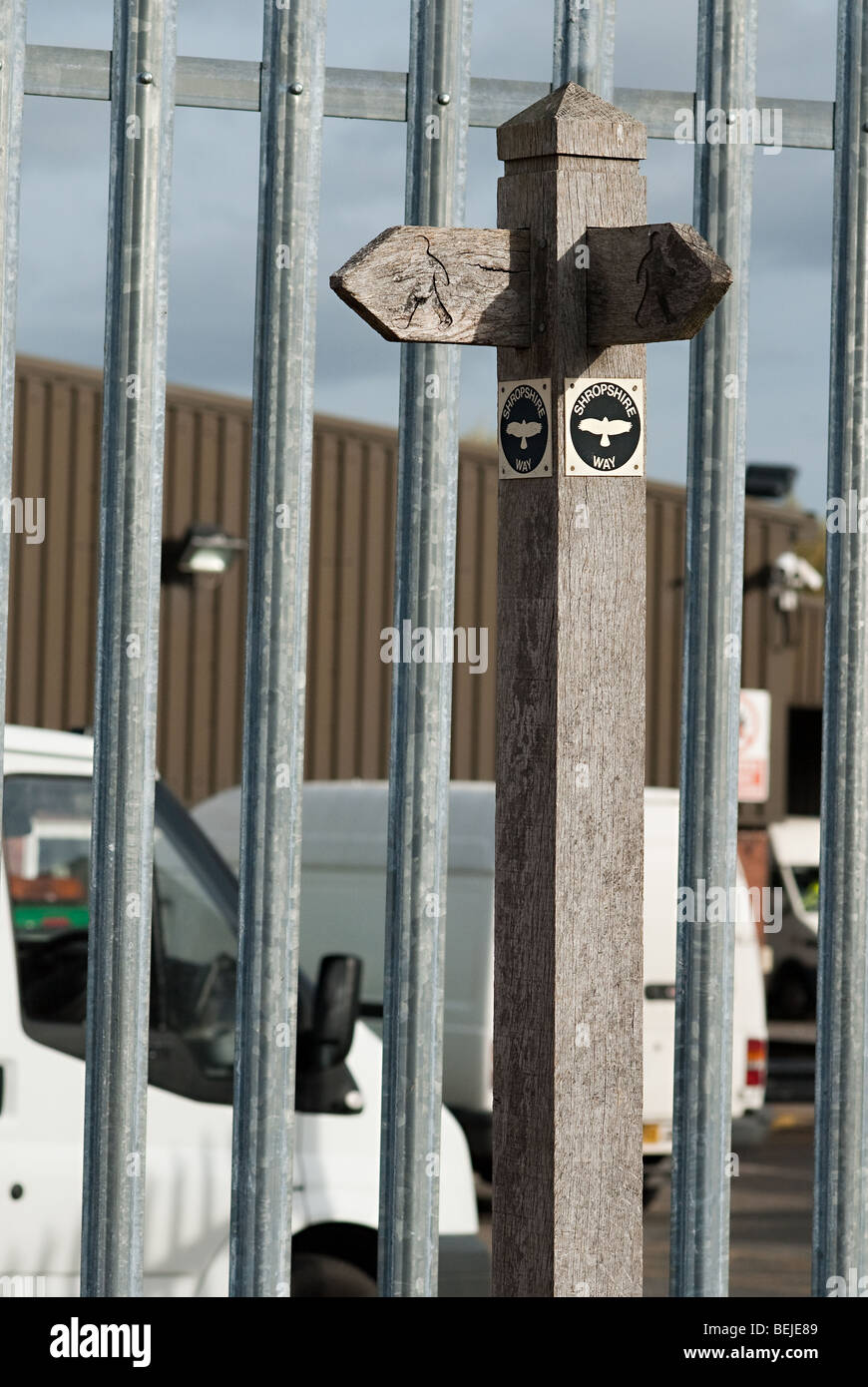 Public right of way sign in front of tall fence Stock Photo