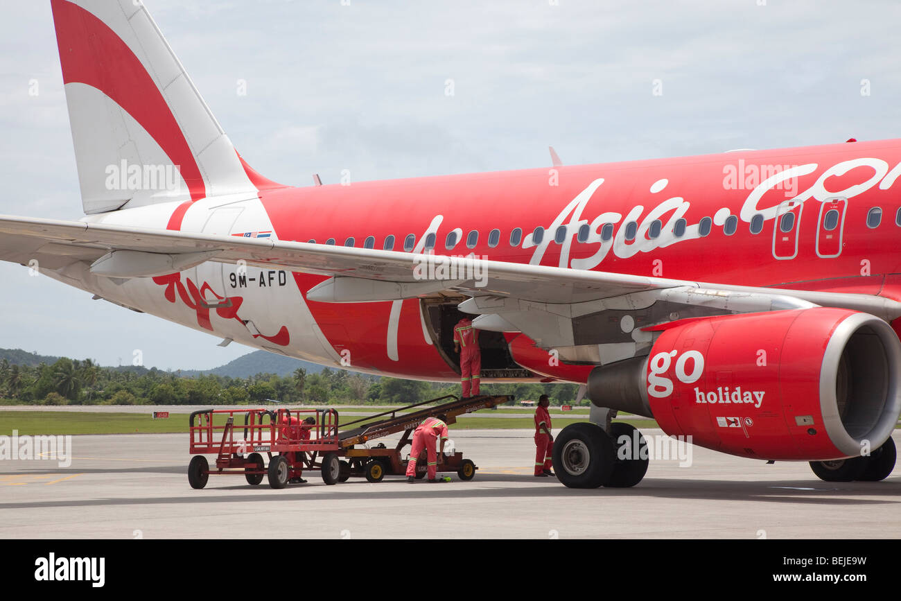 Air Asia Airbus plane being serviced, baggage loading Stock Photo