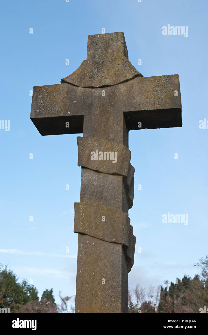 Stone cross against blue sky. Stock Photo