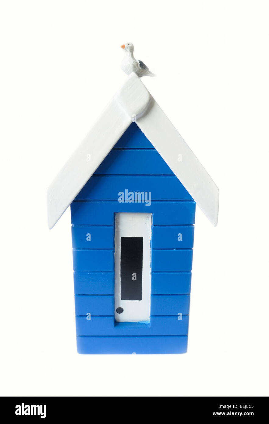 A wooden model of a beach hut with a seagull on the roof Stock Photo