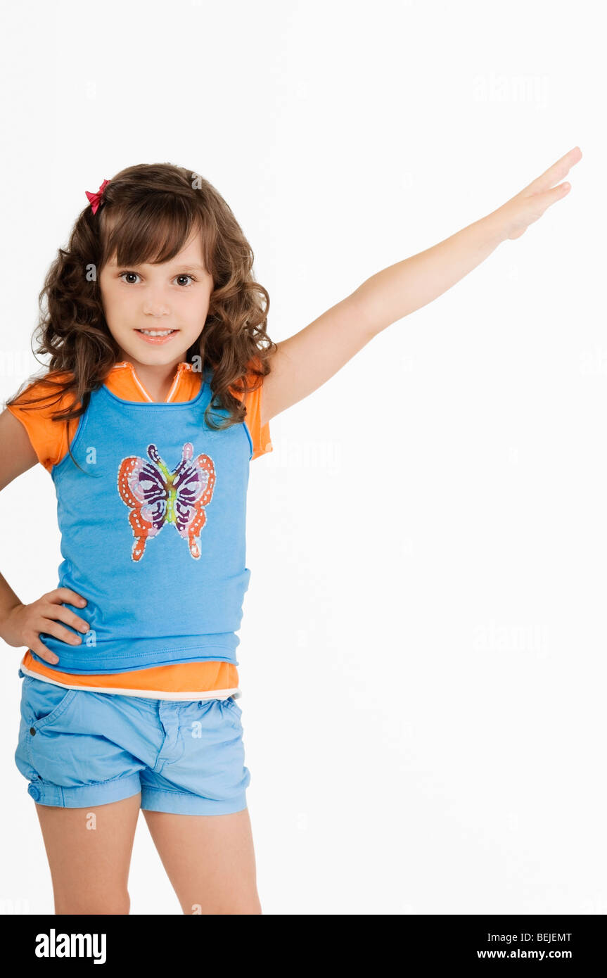 Portrait of a girl standing with her hand on her hip and smiling Stock ...