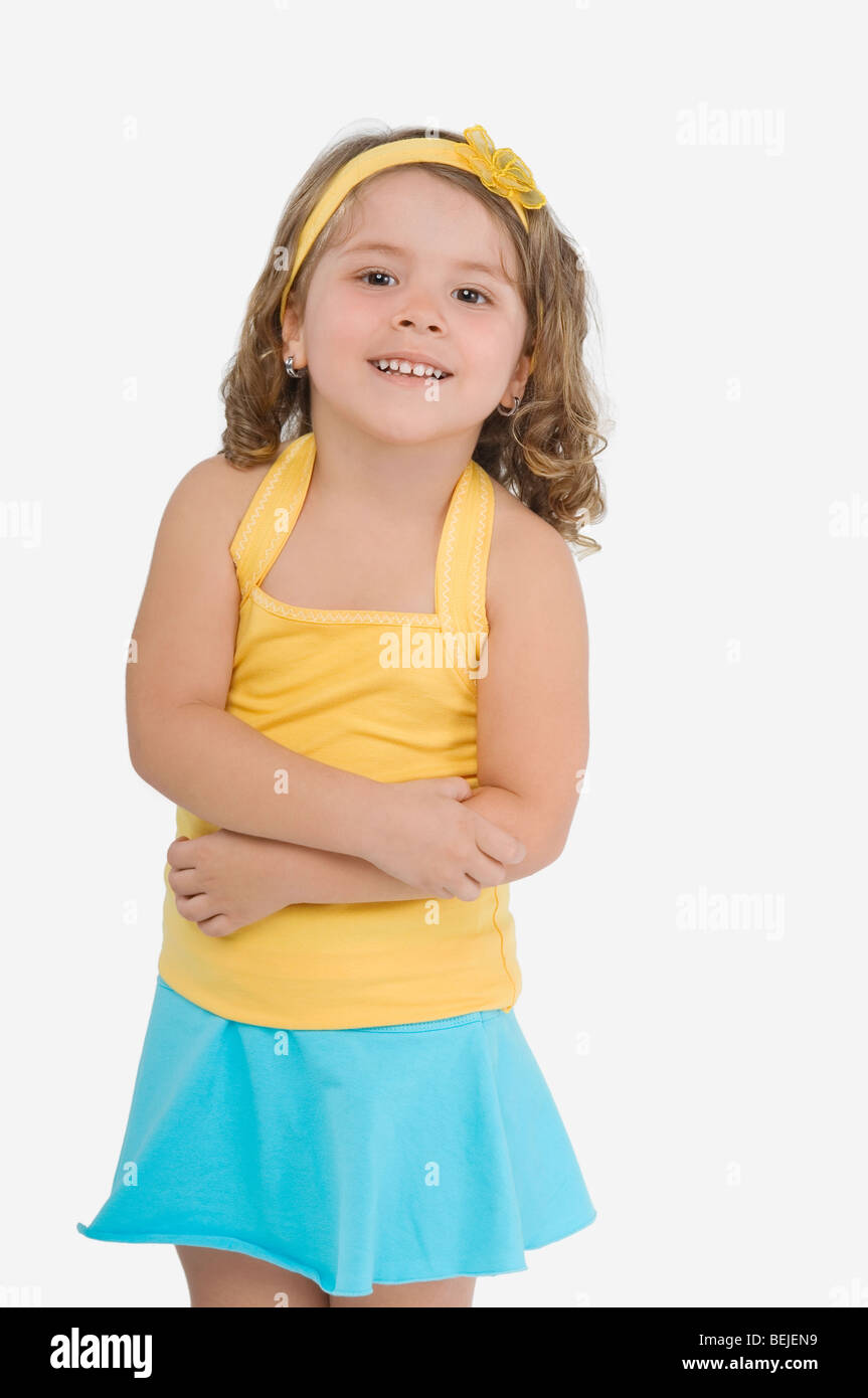 Portrait of a girl standing with her arms crossed and smiling Stock ...