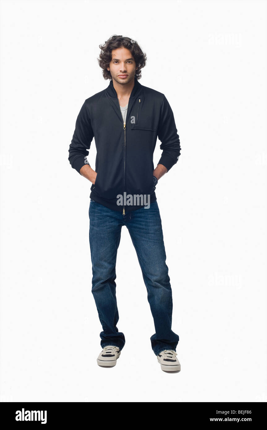 Portrait of a young man standing with his hands in his pockets Stock ...