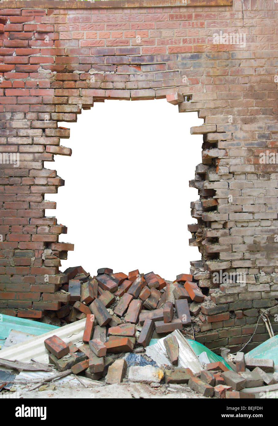 Old brick wall with large hole smashed through. Stock Photo