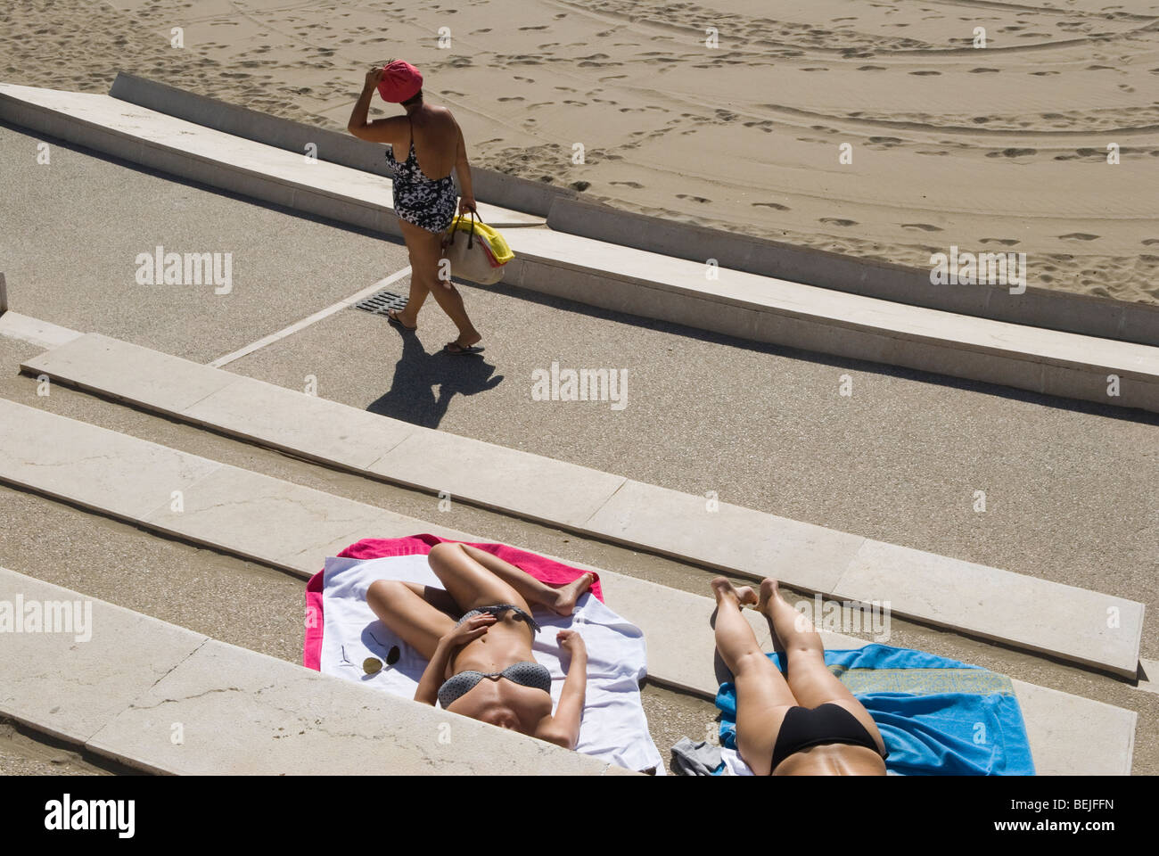 Venice Lido beach Italy. Young Italian women wearing bikini getting a suntan sunbathing, relaxing on holiday. Europe 2000s 2009 HOMER SYKES Stock Photo