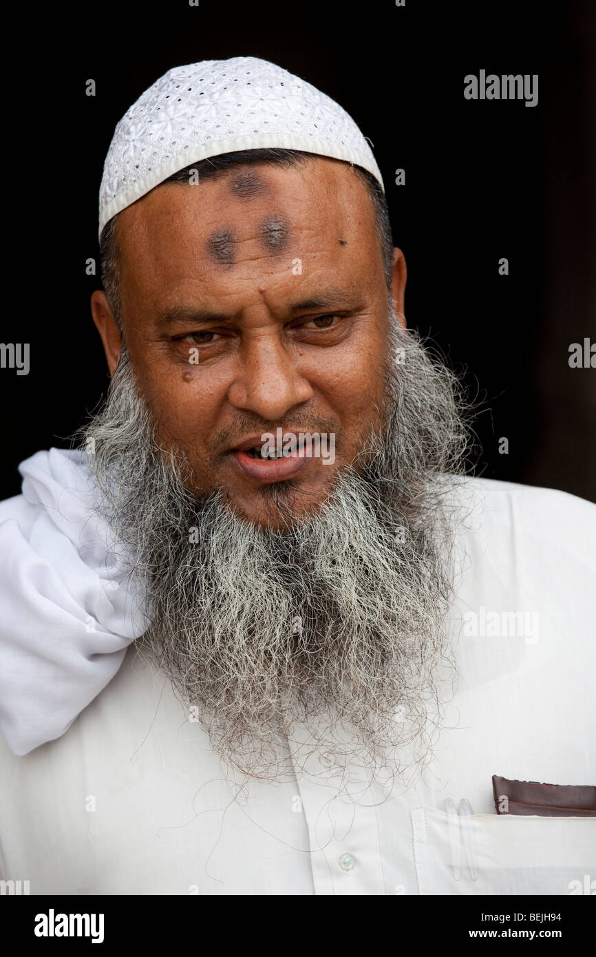 Muslim man with zebibas or raisins, forehead prayer bumps from repeated prostration during prayer in Bagerhat Bangladesh Stock Photo