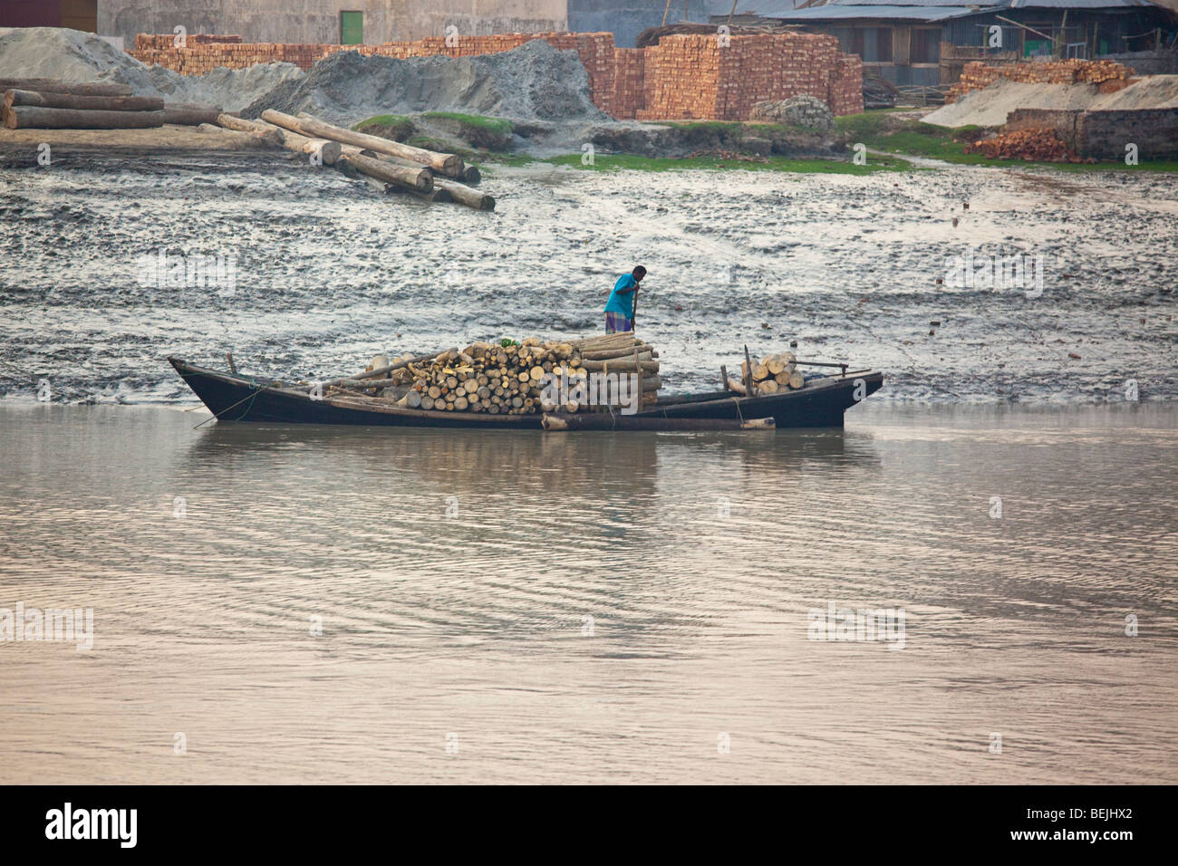 Piled wood in a boat in the Buriganga river in Bangladesh Stock Photo