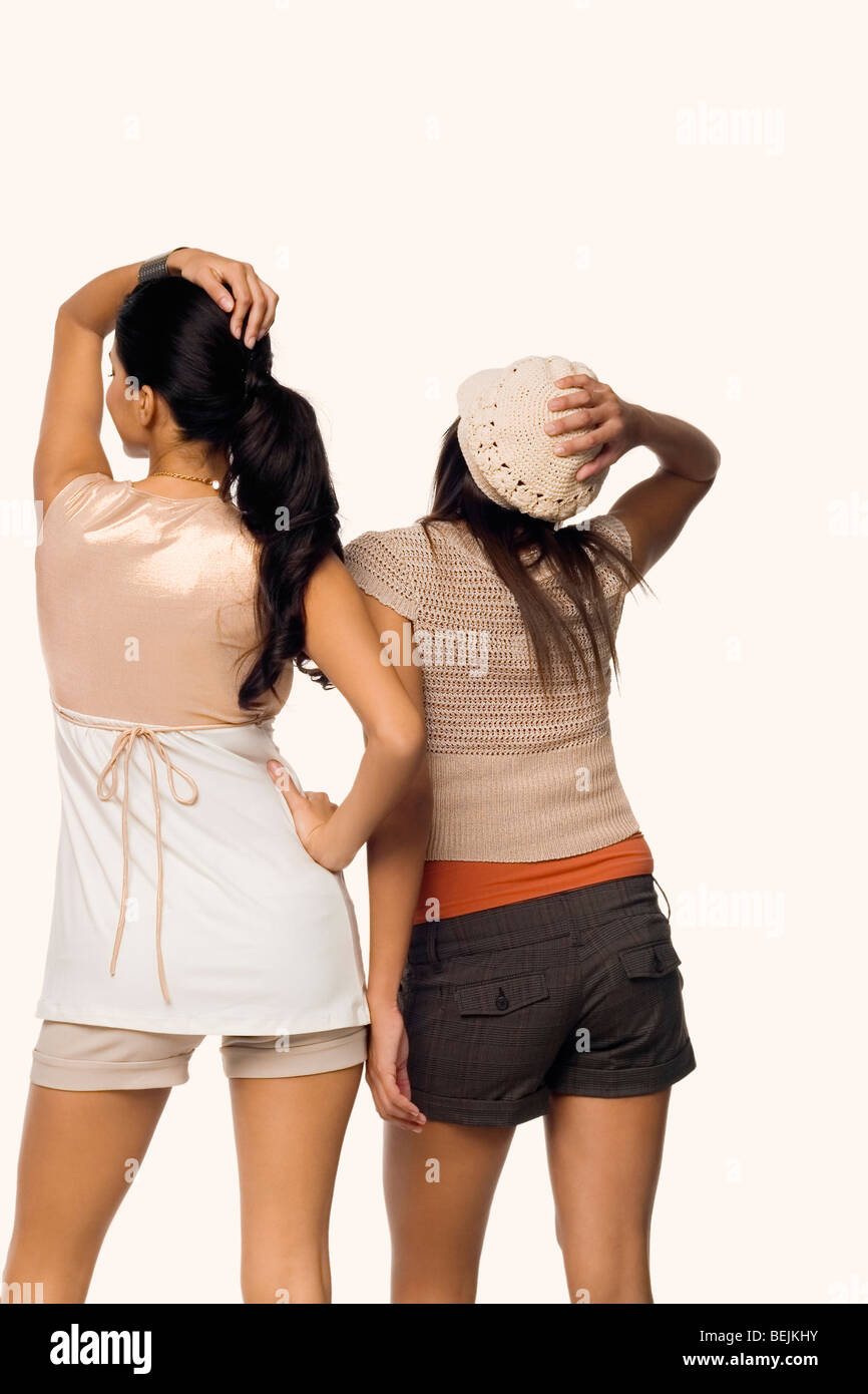Rear view of two young women posing Stock Photo - Alamy
