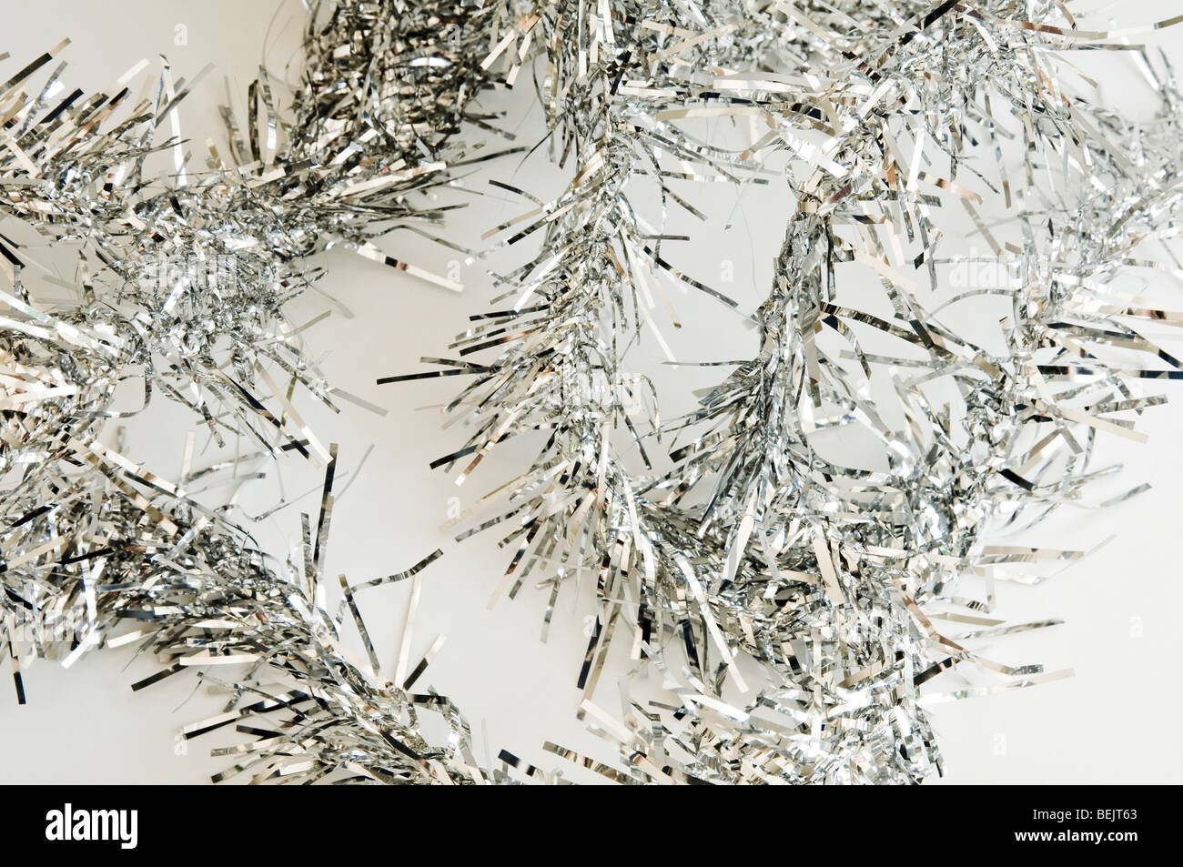 Silver Christmas Tinsel on a white background Stock Photo Alamy