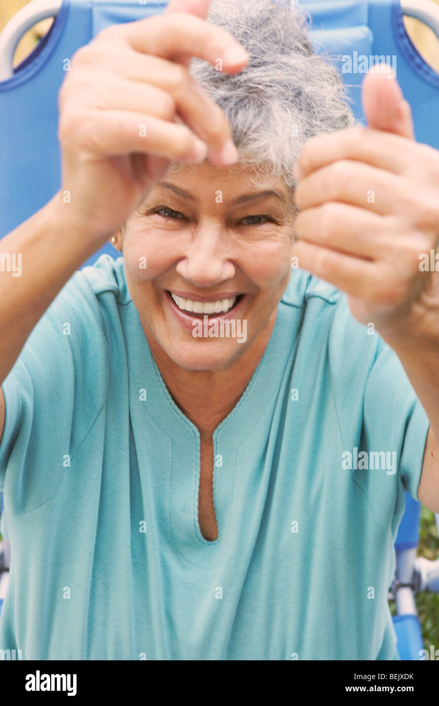 Portrait of a senior woman sitting in a lawn chair and smiling Stock ...
