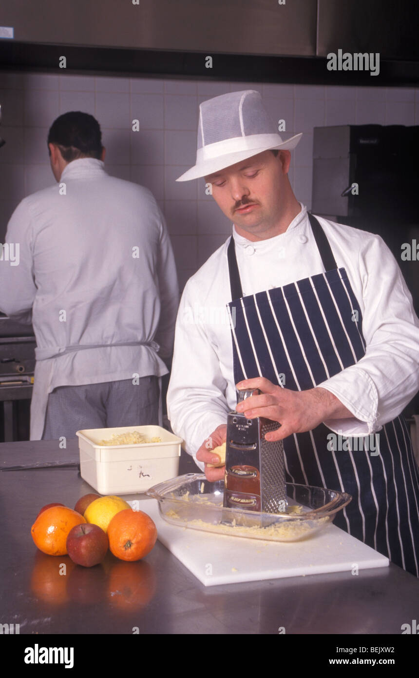 man with down's syndrome working in a kitchen Stock Photo