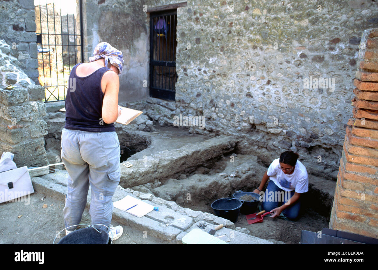 Two archaeologists working at the ruins of Pompeii, Italy Stock Photo