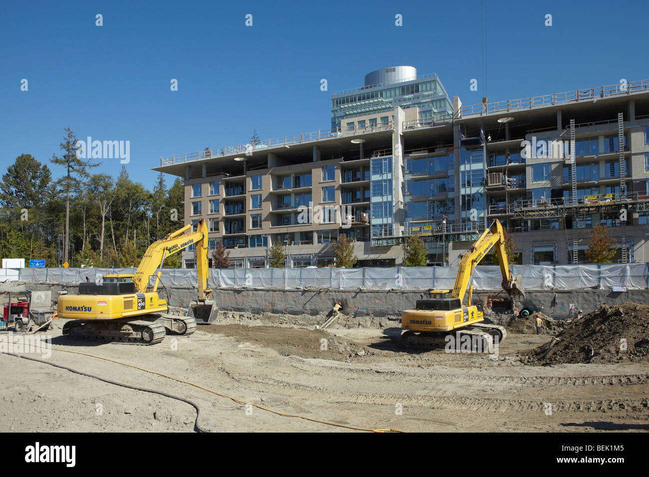 Excavators working on construction site Stock Photo - Alamy