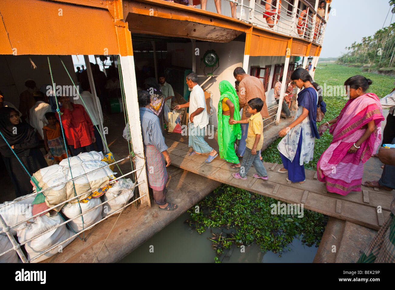 People boarding the Mahsud Rocket Paddle Wheel Boat at a dock on the Brahmaputra River in Bangladesh Stock Photo