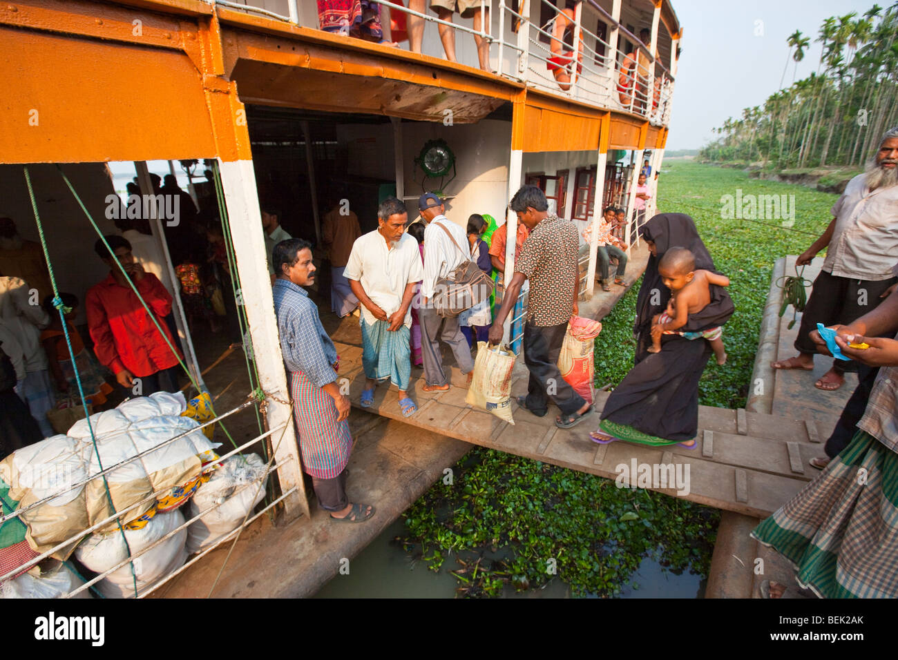 People boarding the Mahsud Rocket Paddle Wheel Boat at a dock on the Brahmaputra River in Bangladesh Stock Photo