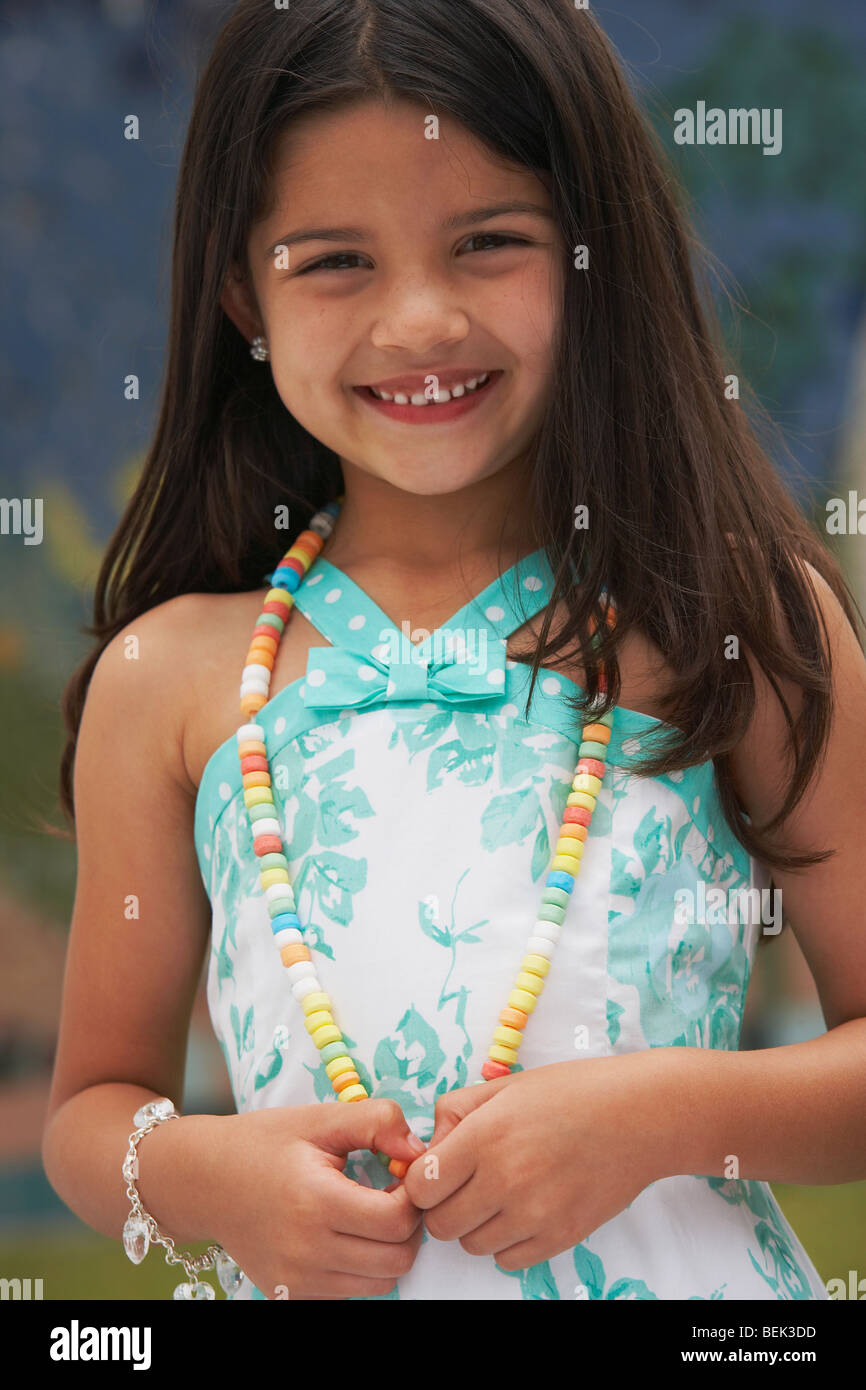 Portrait of a girl wearing a candy necklace and smiling Stock Photo