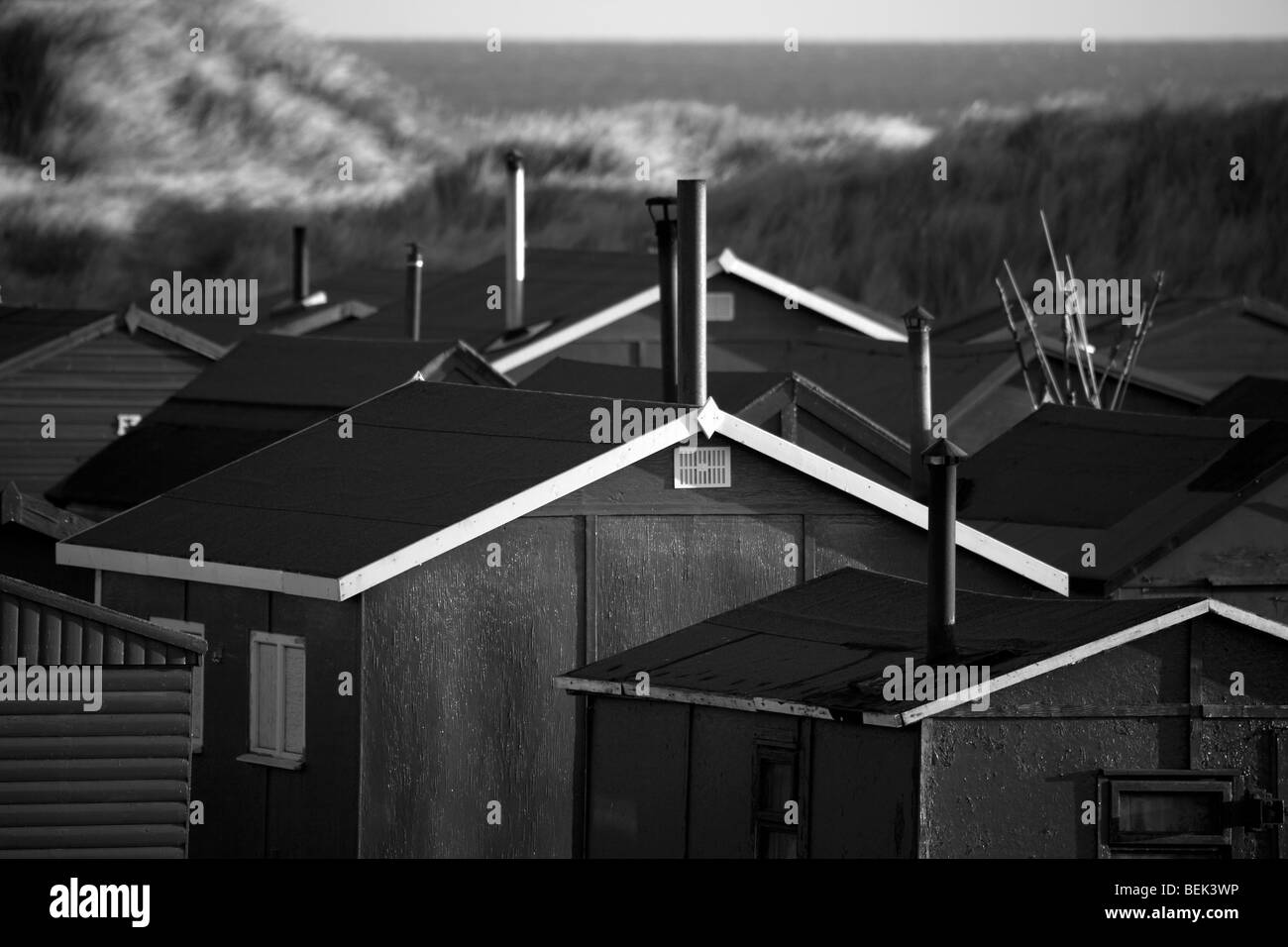 Several Tarpaulin roofed Fisherman's huts with chimneys; A hundred “South Gare Fishermen’s Association” cabins. Multiple sheds with doors & windows Stock Photo