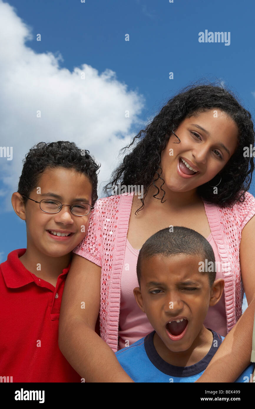 Portrait of two boys and a teenage girl smiling Stock Photo - Alamy