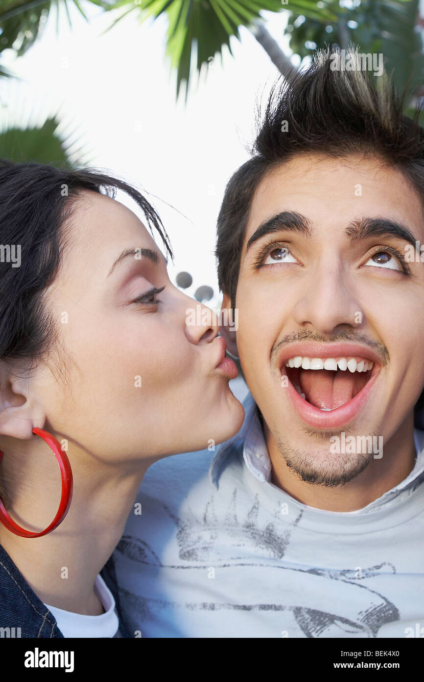 Close-up of a young woman kissing a young man Stock Photo - Alamy