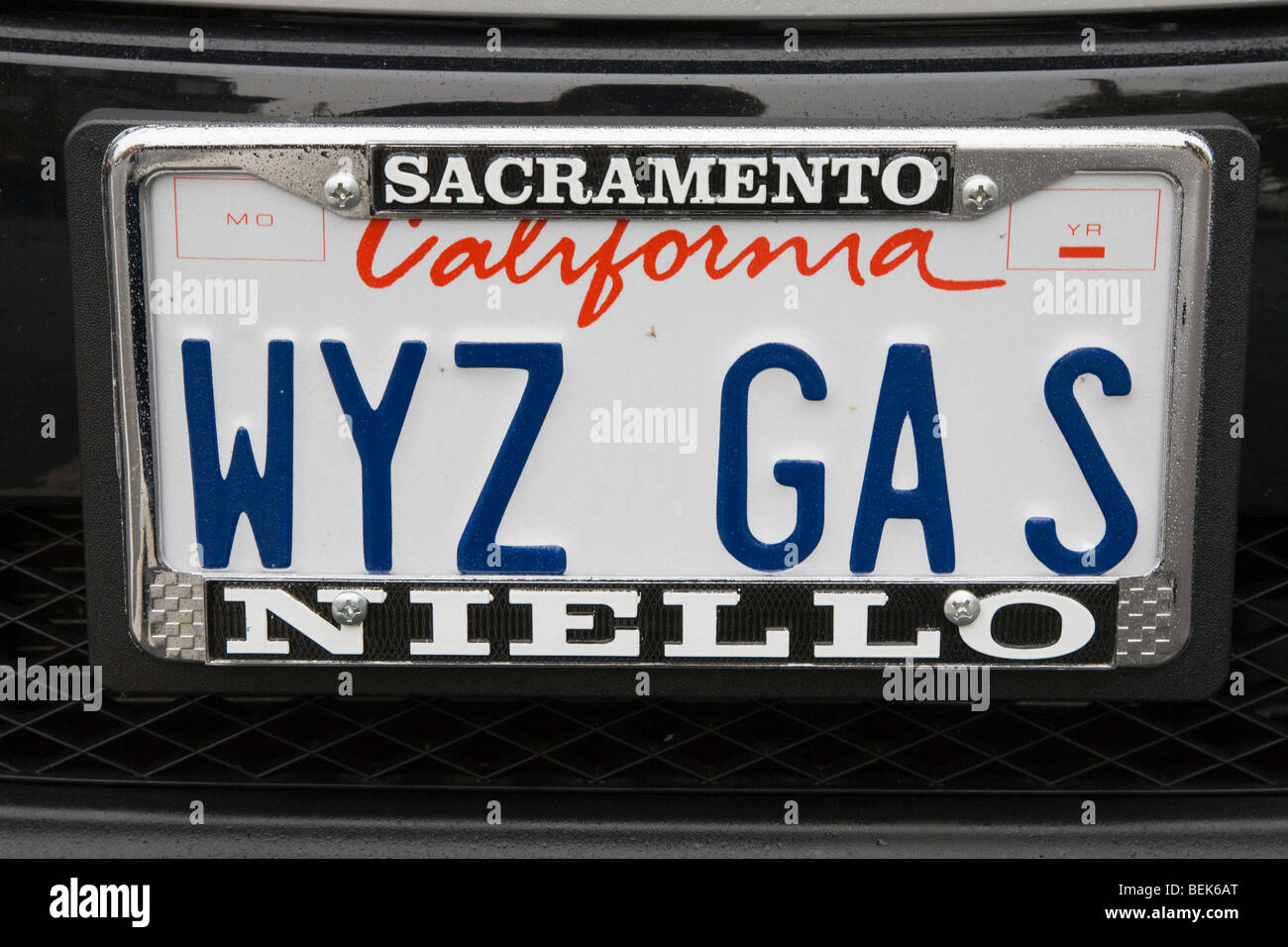 Close up of a 'WYZ GAS' (Wise Gas) license plate on a Smart Car Fortwo